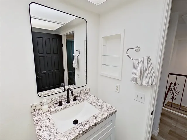 a bathroom with a sink and mirror