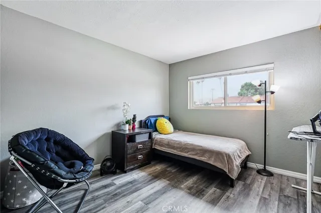 a bedroom with a bed a table and chair