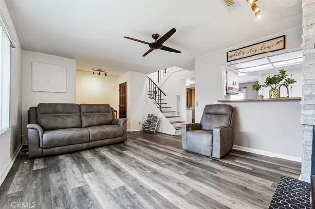 a living room with furniture and wooden floor