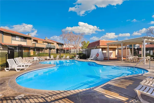 a view of a swimming pool with outdoor seating