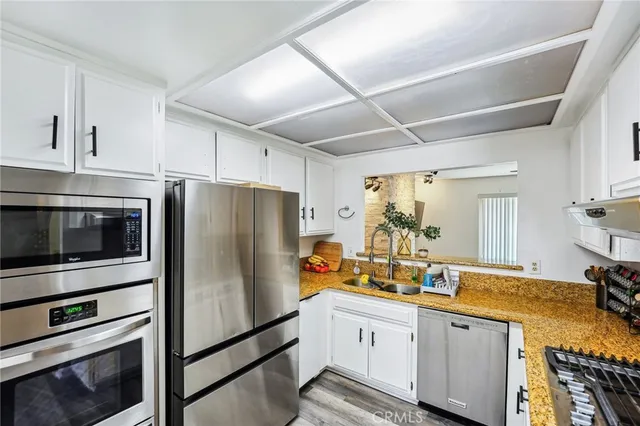 a kitchen with granite countertop stainless steel appliances and counter space