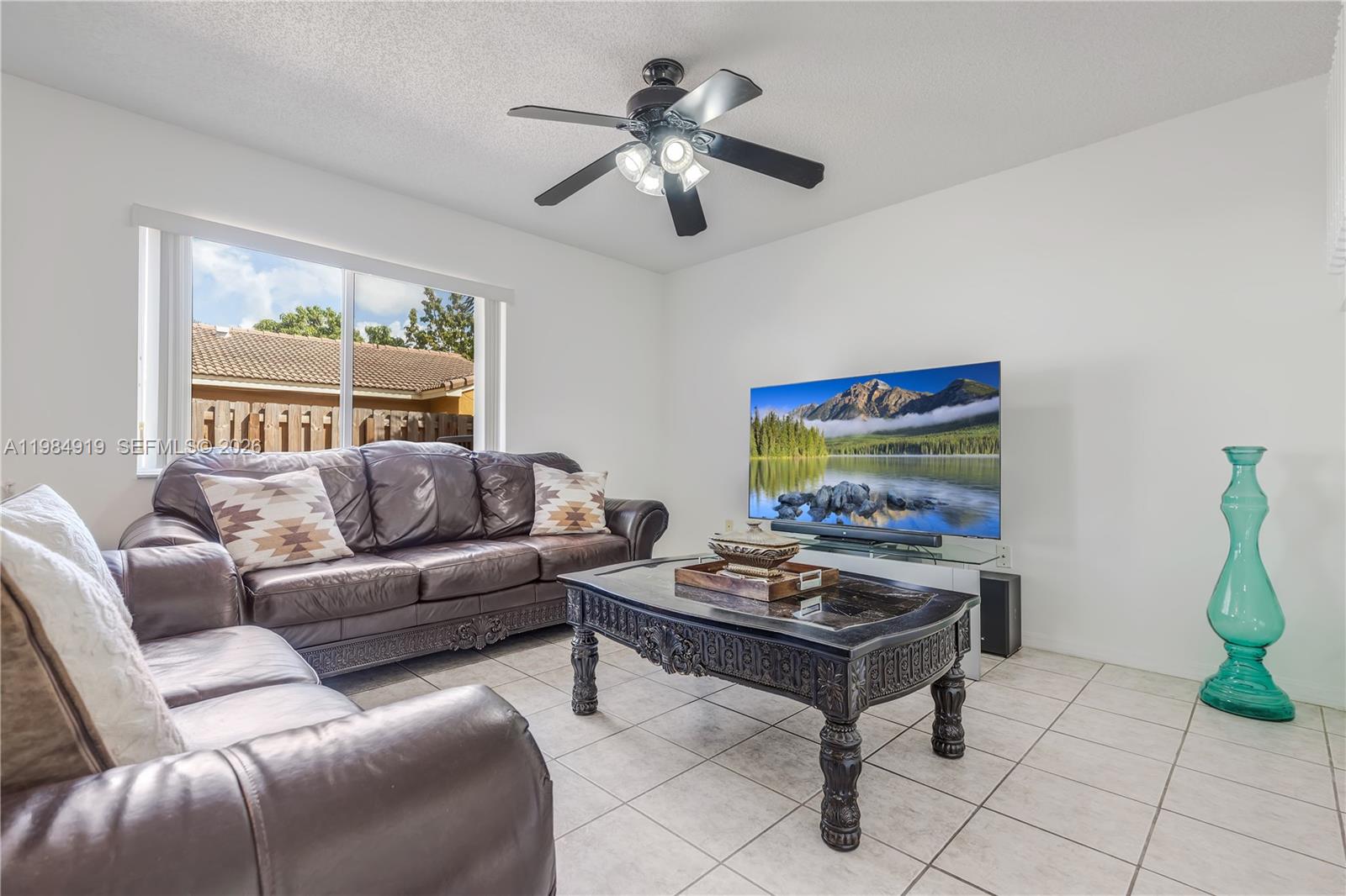 16323 Southwest 97th Street Miami, FL 33196 - Photo 13 of 44 a living room with furniture and a chandelier