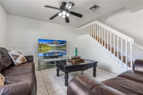 a living room with furniture and a flat screen tv