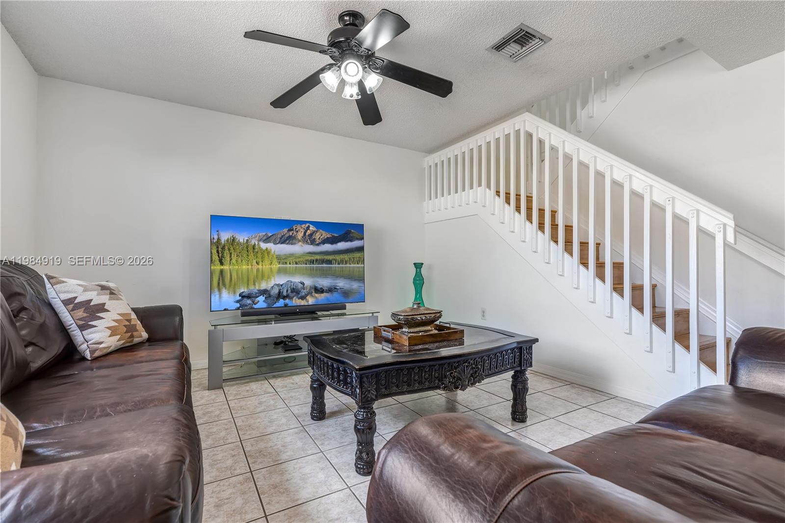 16323 Southwest 97th Street Miami, FL 33196 - Photo 14 of 44 a living room with furniture and a flat screen tv