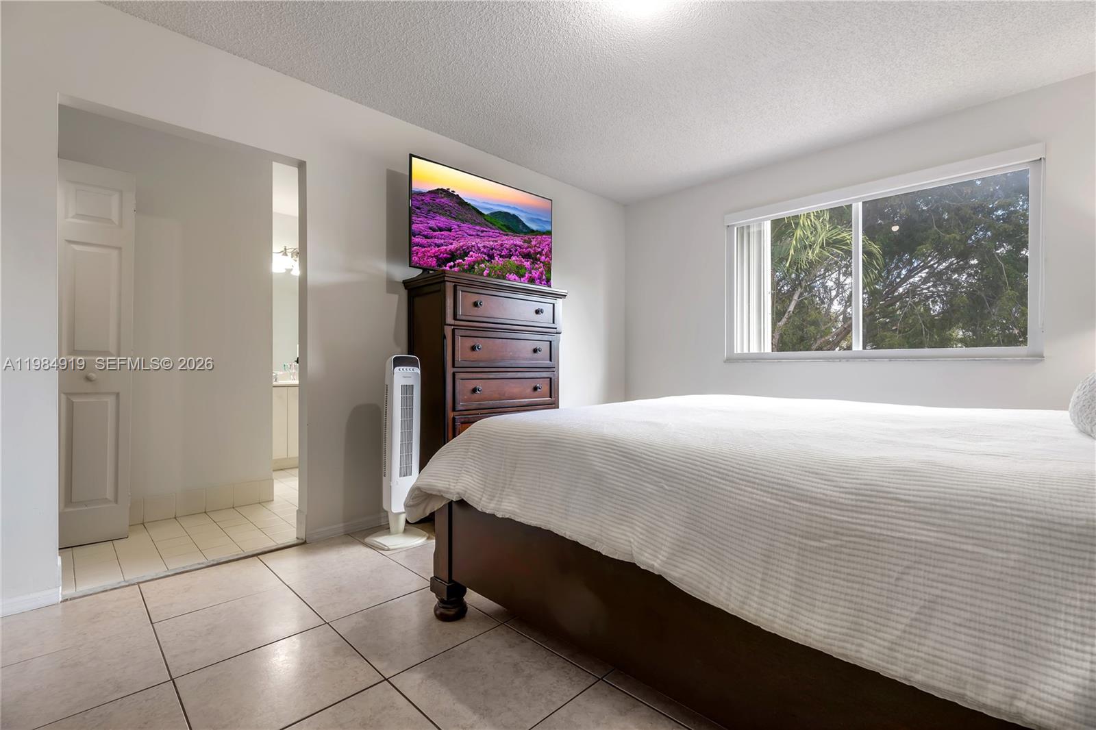16323 Southwest 97th Street Miami, FL 33196 - Photo 17 of 44 a spacious bedroom with a bed and a window