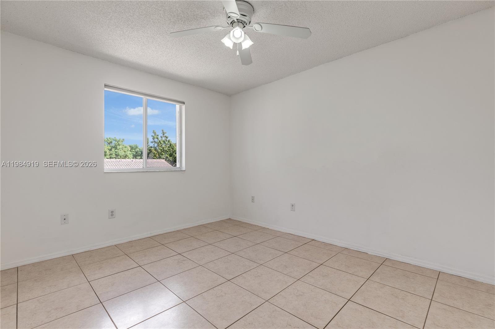 16323 Southwest 97th Street Miami, FL 33196 - Photo 22 of 44 a view of an empty room with a window