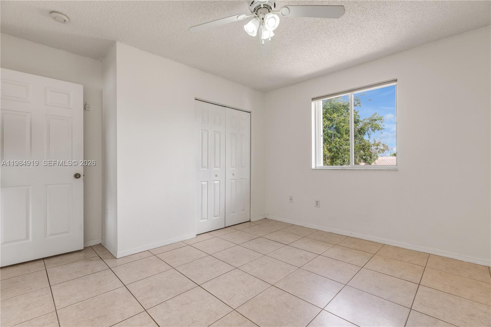 16323 Southwest 97th Street Miami, FL 33196 - Photo 23 of 44 a view of an empty room with a window