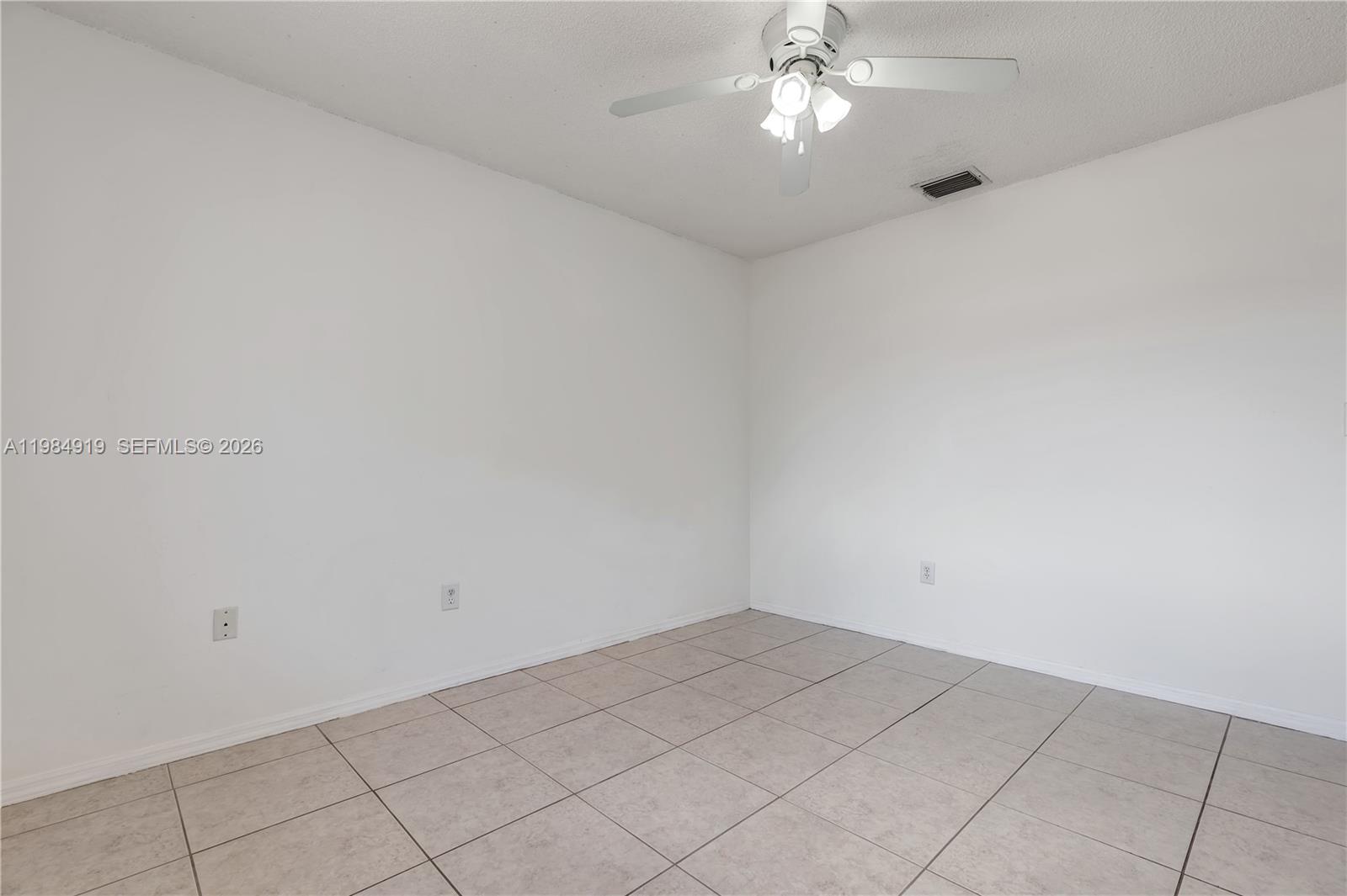 16323 Southwest 97th Street Miami, FL 33196 - Photo 24 of 44 an empty room with a chandelier fan