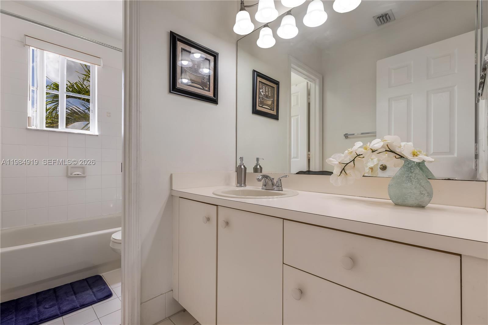 16323 Southwest 97th Street Miami, FL 33196 - Photo 25 of 44 a bathroom with a sink and a mirror