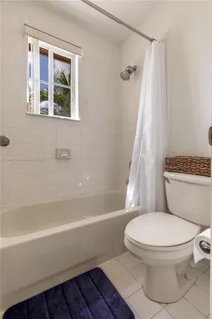 a bathroom with a toilet and a bath tub