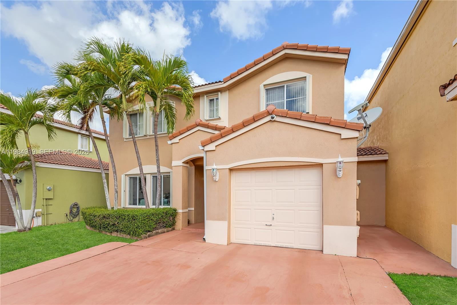 16323 Southwest 97th Street Miami, FL 33196 - Photo 3 of 44 a front view of a house with a yard and garage