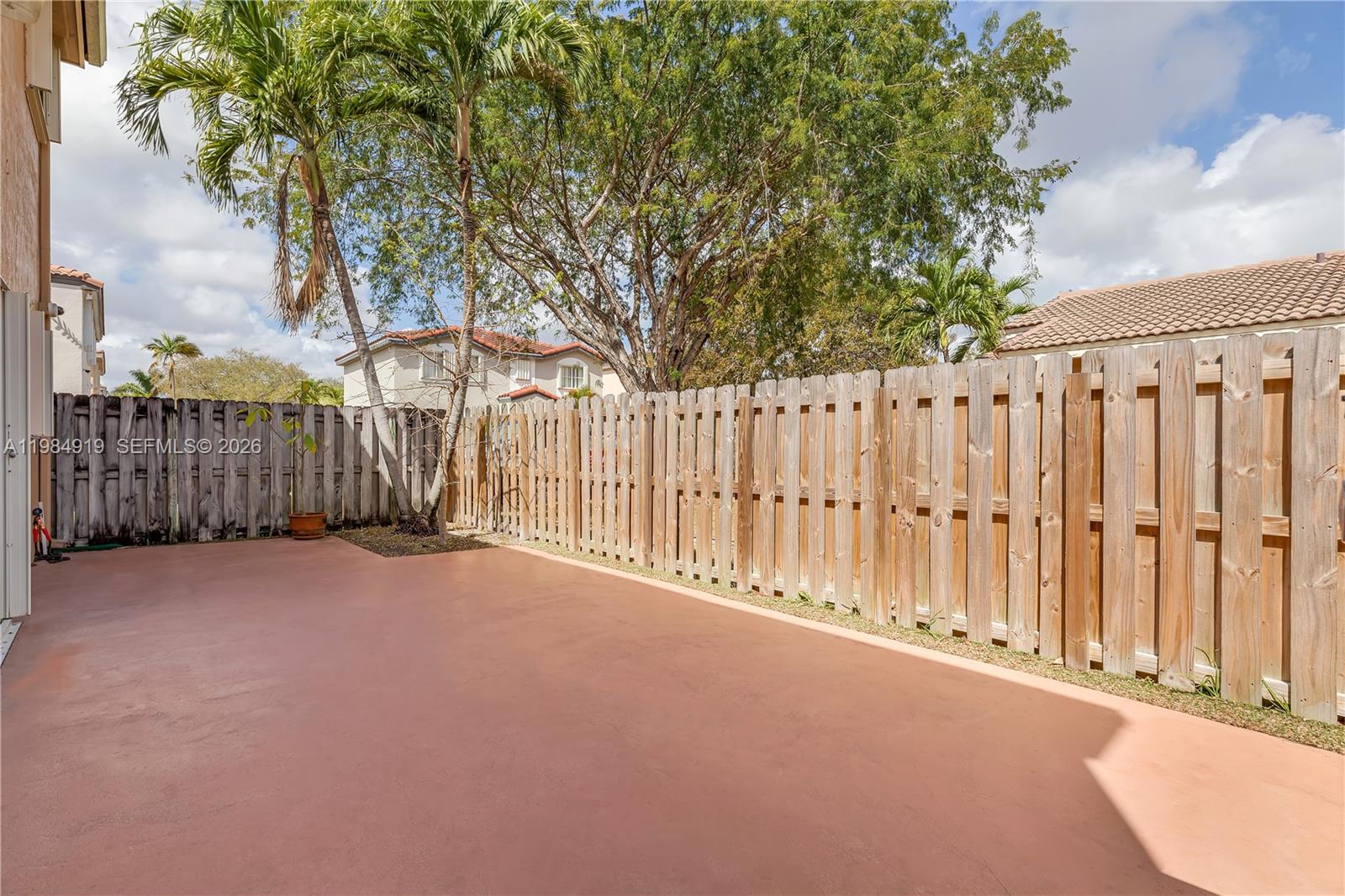 16323 Southwest 97th Street Miami, FL 33196 - Photo 34 of 44 a view of a street with a large tree