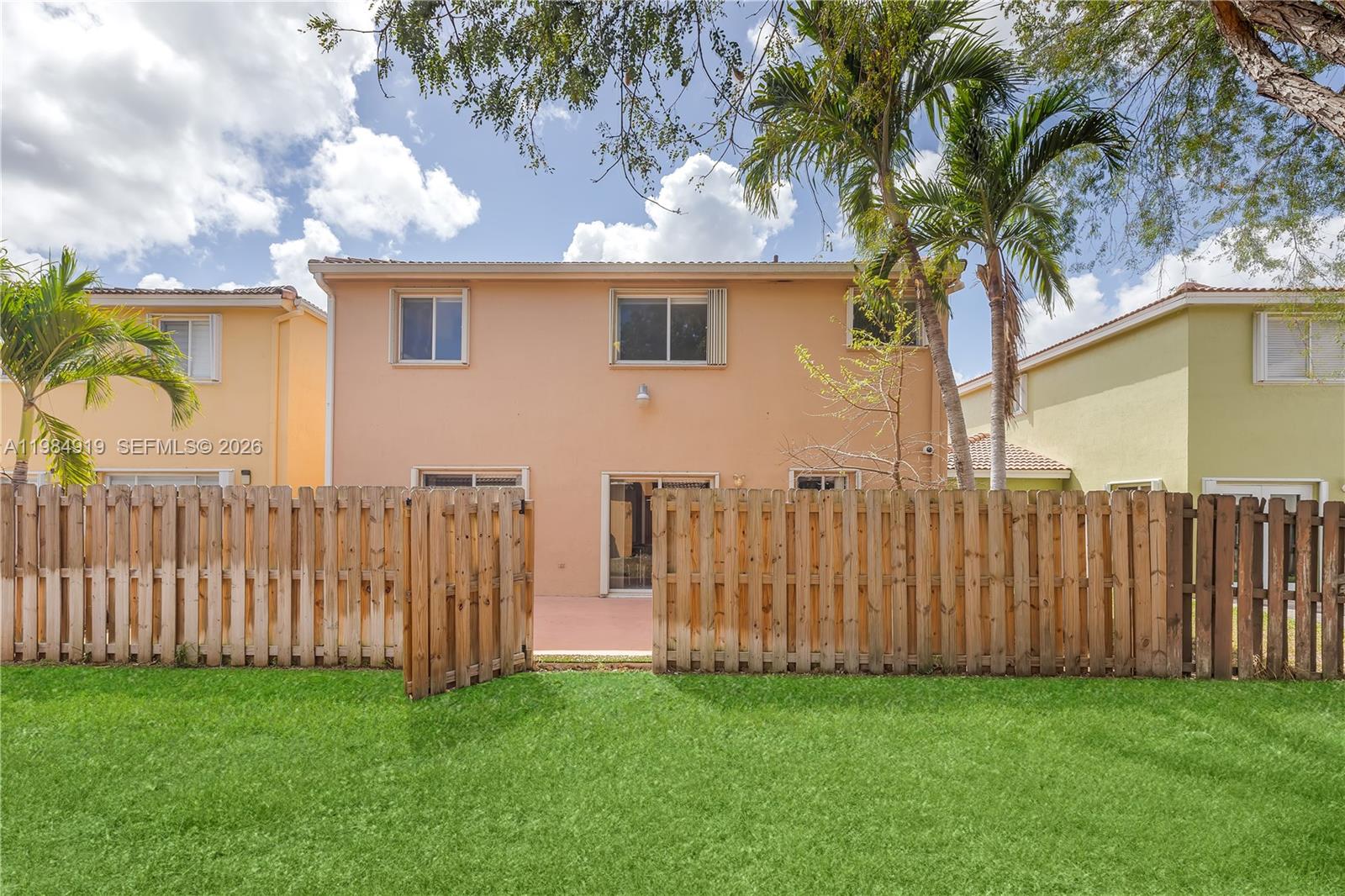 16323 Southwest 97th Street Miami, FL 33196 - Photo 37 of 44 a view of a wooden fence under a large tree