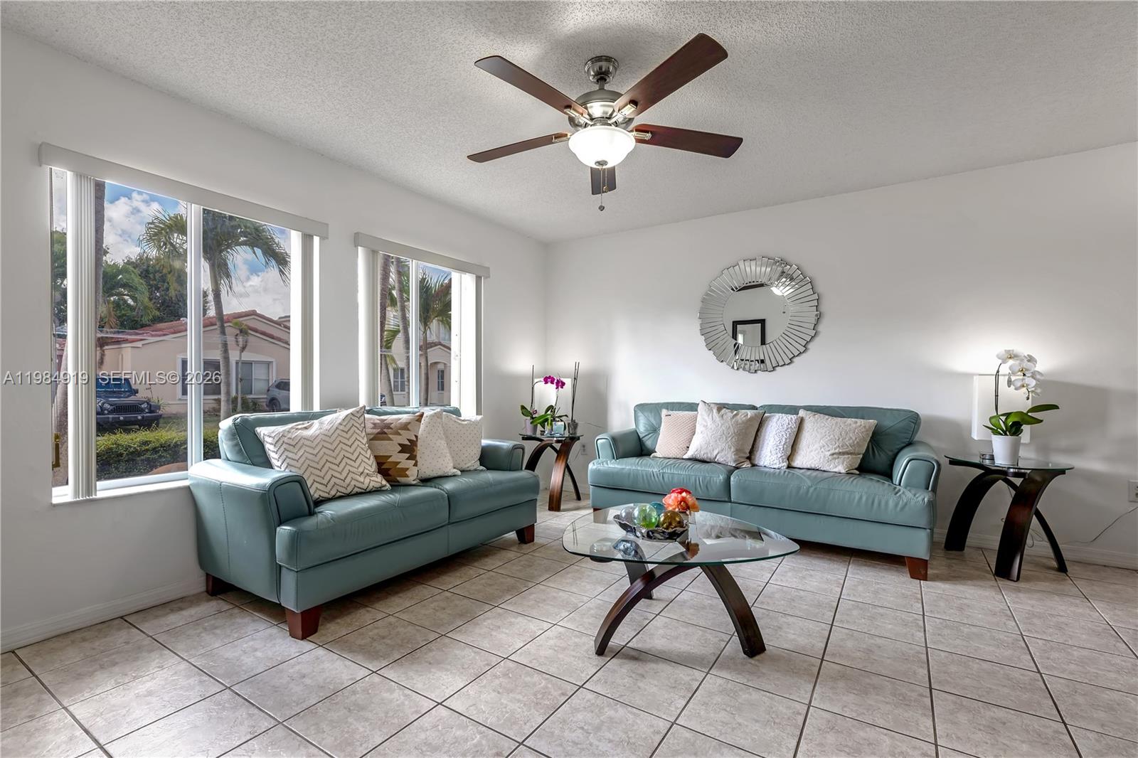 16323 Southwest 97th Street Miami, FL 33196 - Photo 4 of 44 a living room with furniture and a large window