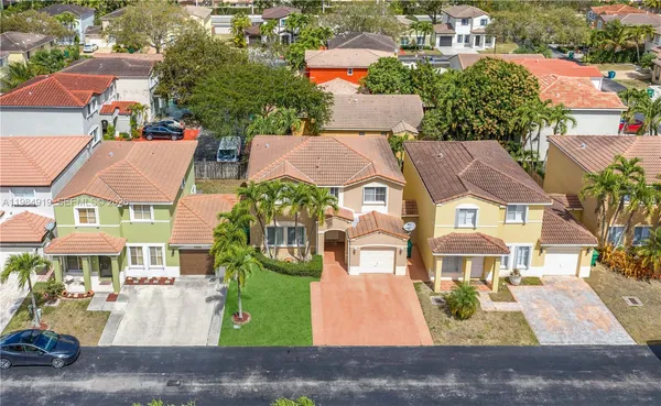 an aerial view of residential houses with outdoor space