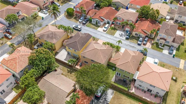 an aerial view of residential houses with outdoor space