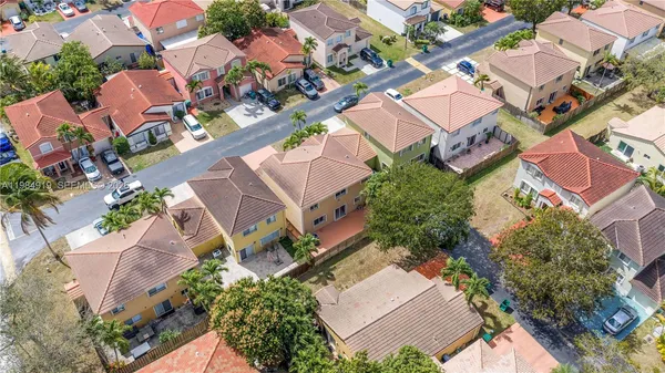 an aerial view of a house with a yard and a garage