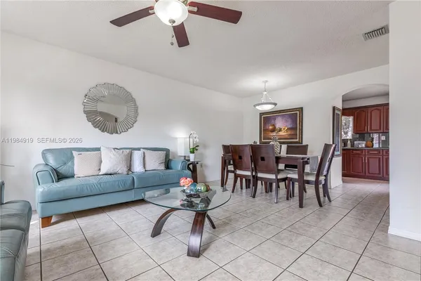 a living room with furniture and kitchen view