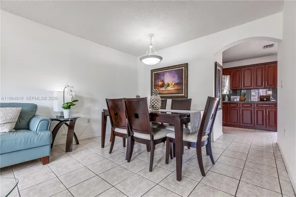 a dining room with furniture and window