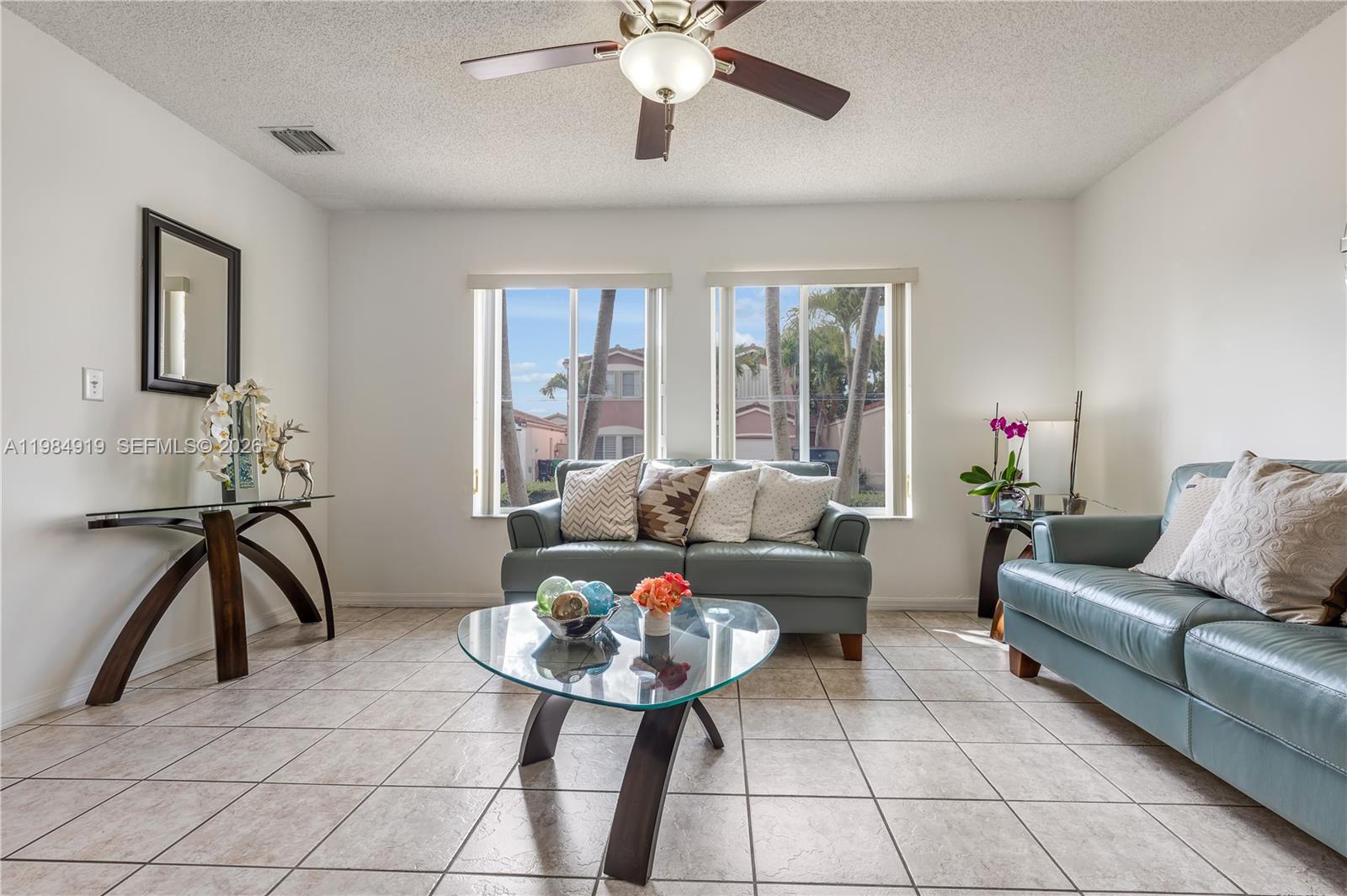 16323 Southwest 97th Street Miami, FL 33196 - Photo 7 of 44 a living room with furniture and a chandelier
