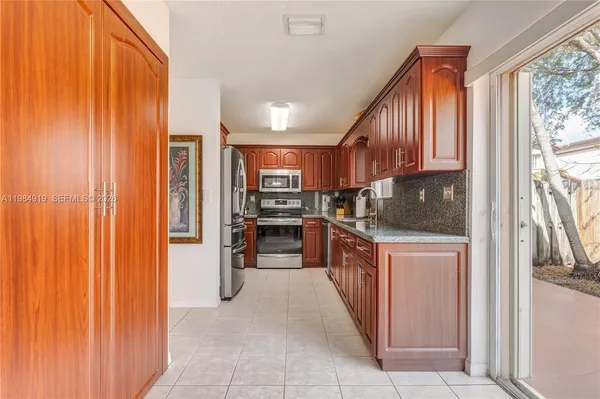 a kitchen with stainless steel appliances a refrigerator and wooden cabinets