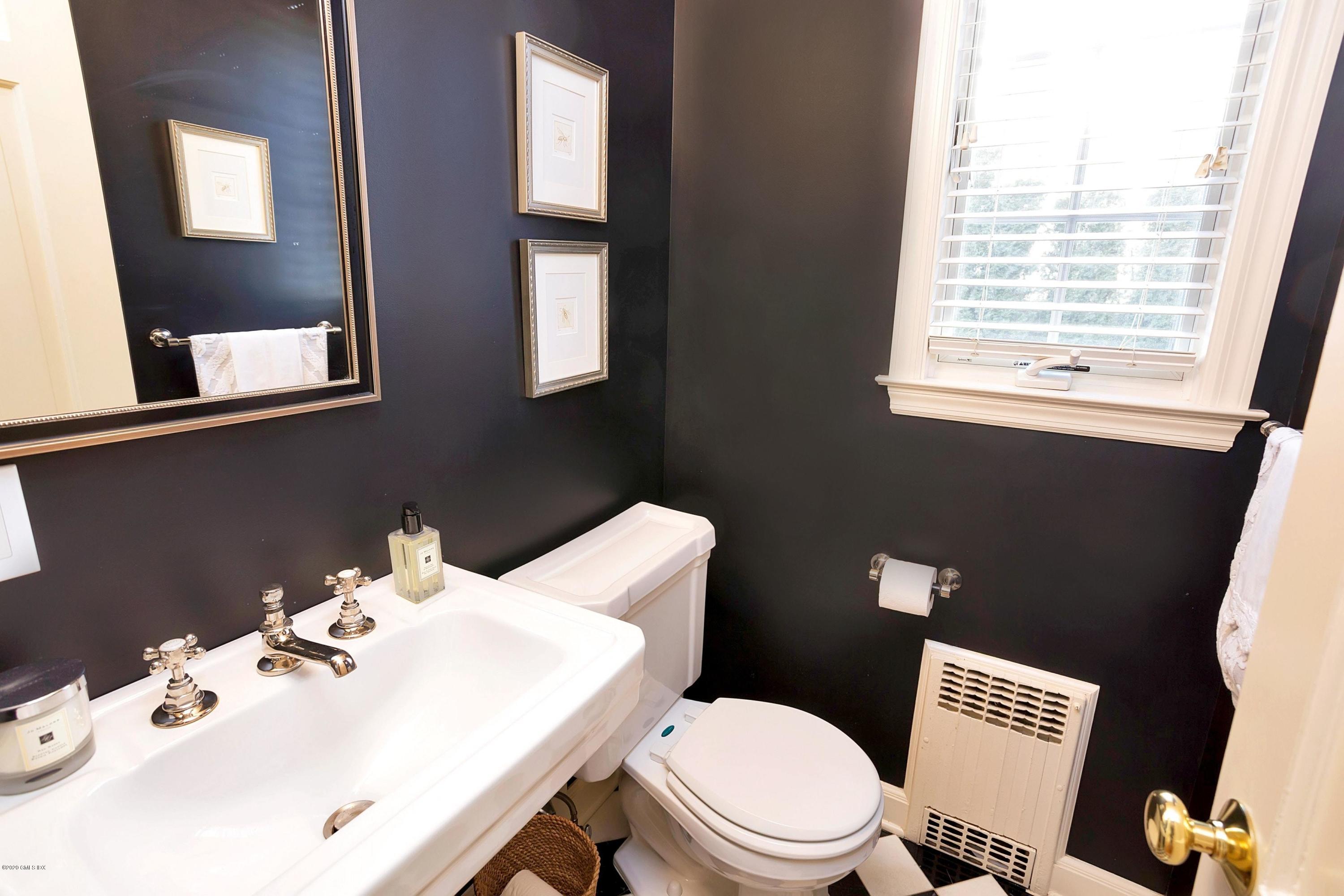 111 Lockwood Road Riverside, CT 06878 - Photo 13 of 35 a bathroom with a sink a toilet and mirror