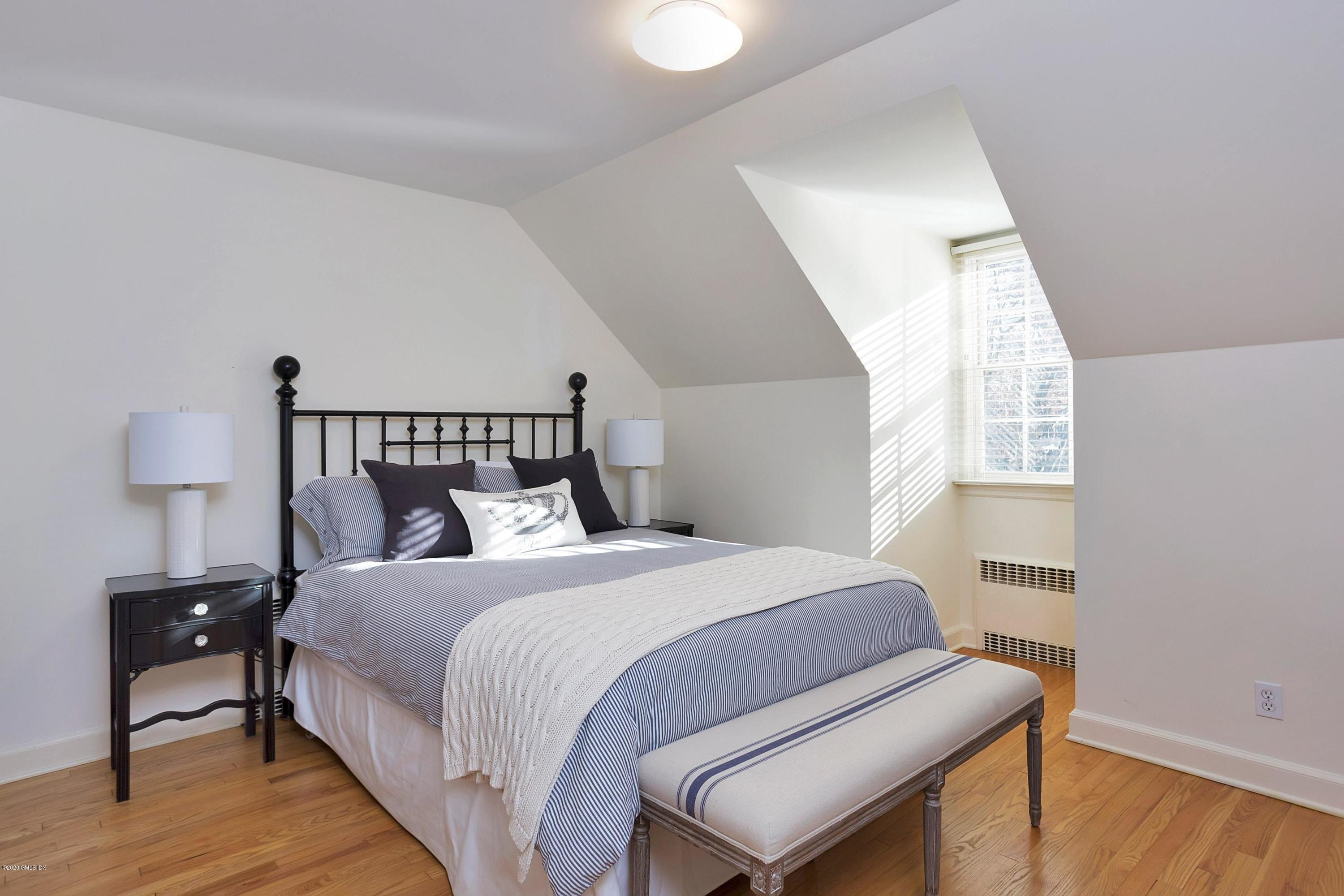 111 Lockwood Road Riverside, CT 06878 - Photo 20 of 35 a bedroom with a bed and wooden floor