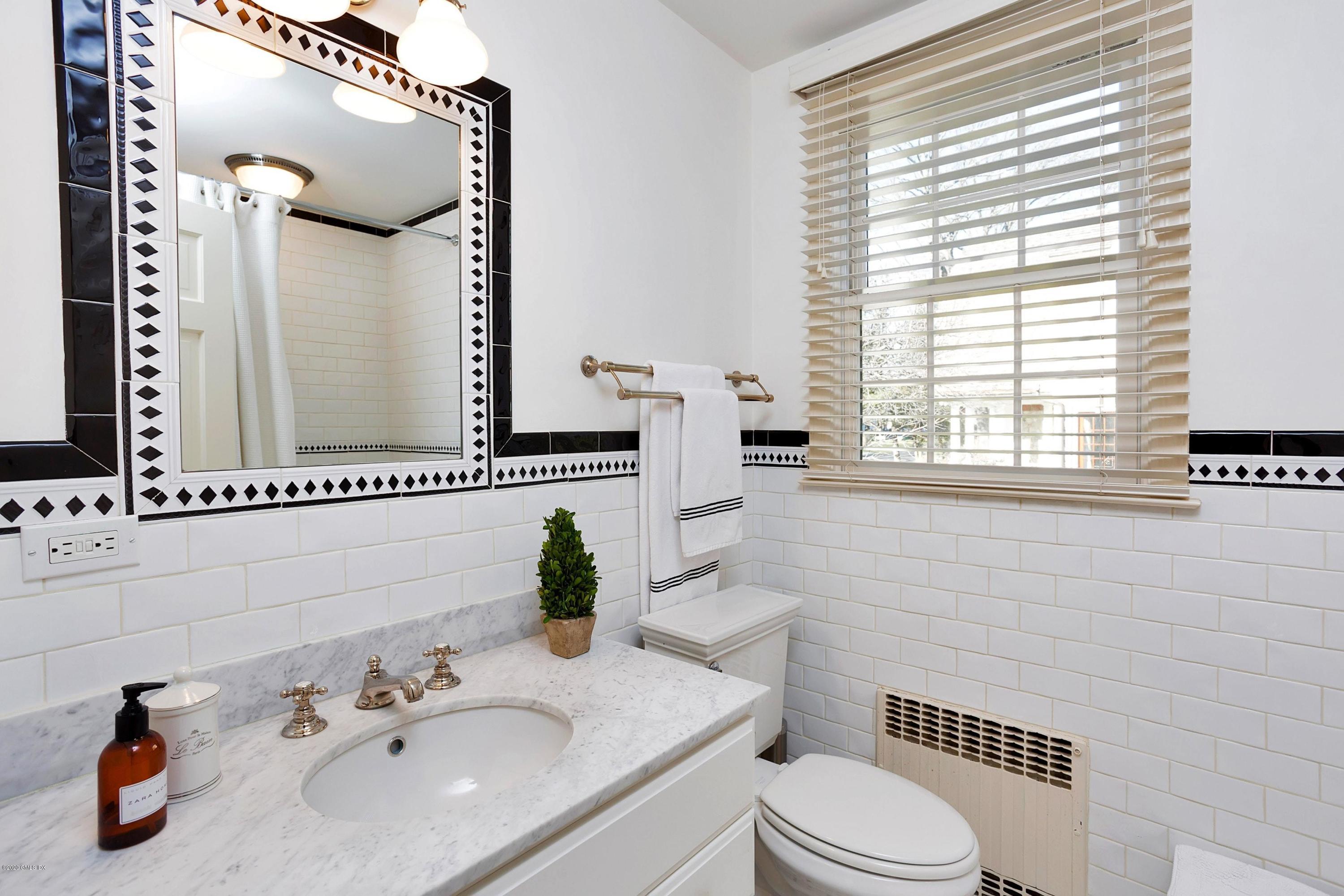 111 Lockwood Road Riverside, CT 06878 - Photo 24 of 35 a bathroom with a sink a toilet and a mirror