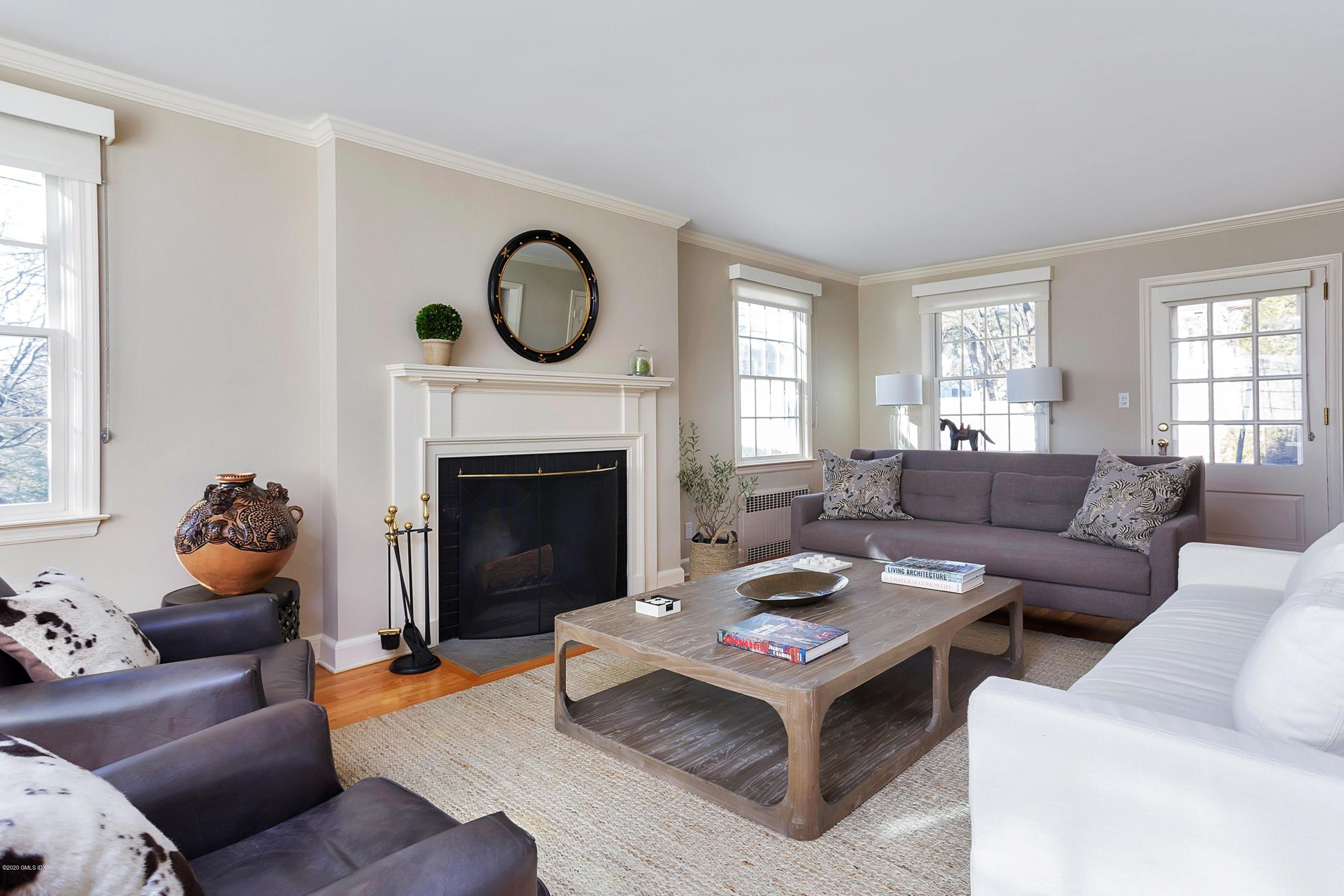 111 Lockwood Road Riverside, CT 06878 - Photo 5 of 35 a living room with furniture a fireplace a window and a lamp