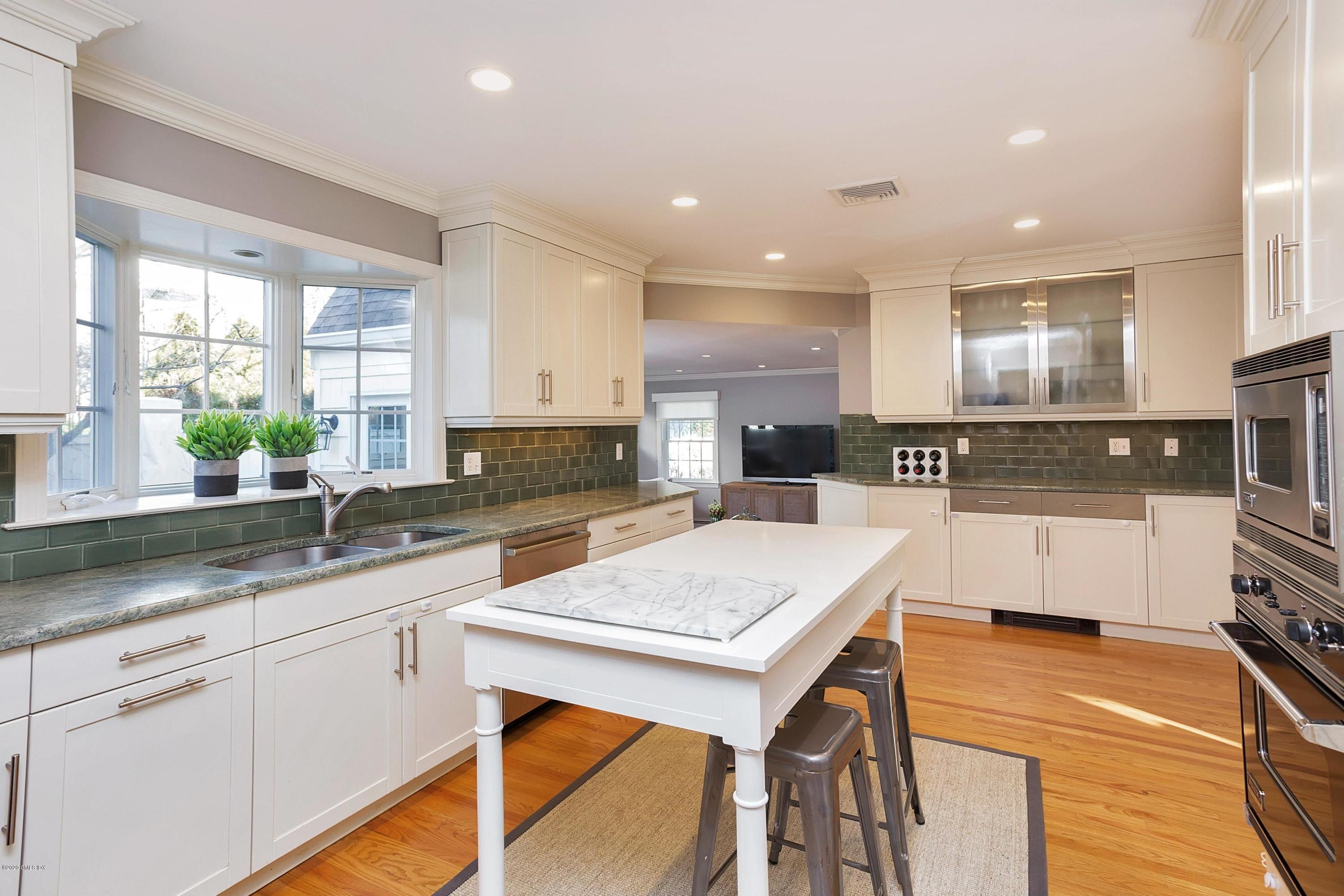111 Lockwood Road Riverside, CT 06878 - Photo 8 of 35 a kitchen with a sink a stove a refrigerator and cabinets