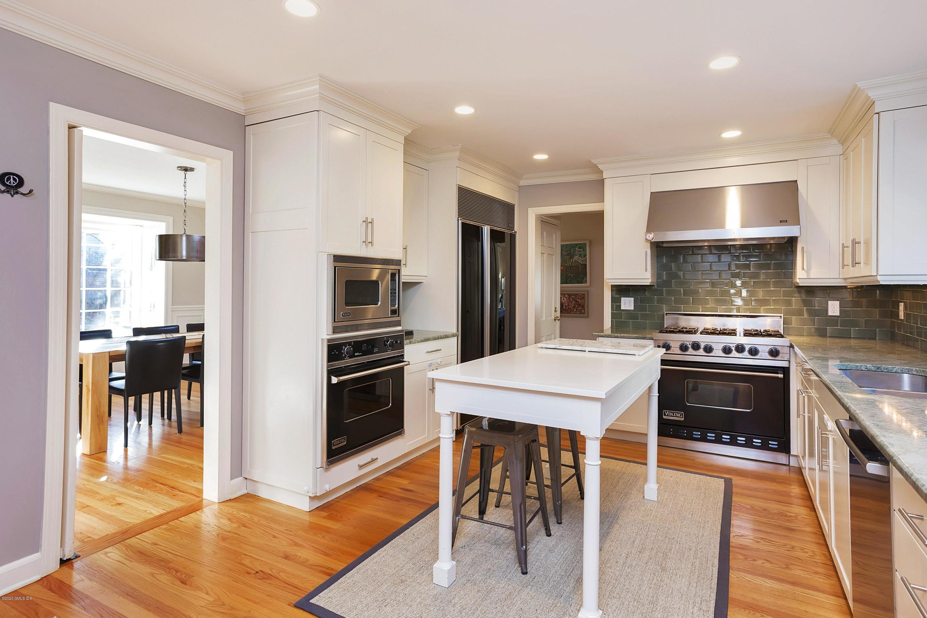 111 Lockwood Road Riverside, CT 06878 - Photo 10 of 35 a kitchen with stainless steel appliances kitchen island granite countertop a stove top oven a sink and a refrigerator