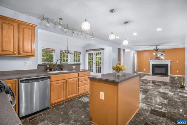 a kitchen with granite countertop cabinets sink and window