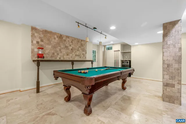 a room with pool table and windows