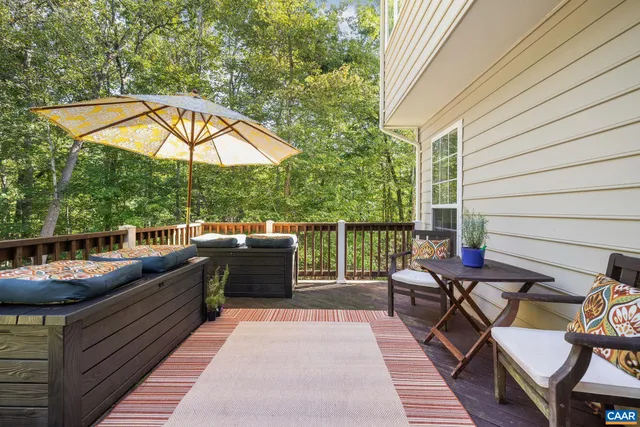 an outdoor sitting area with furniture and umbrella