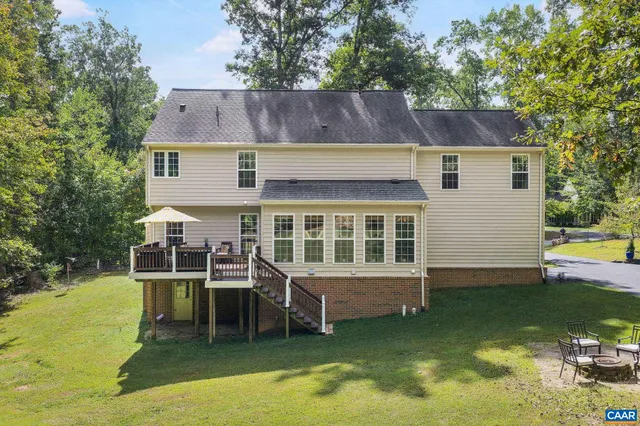 a view of a house with a yard and sitting area