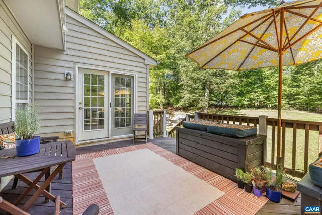 a view of a patio with a table and chairs under an umbrella
