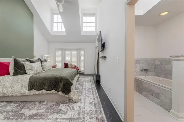 a spacious bedroom with a bed and a window