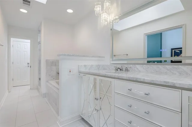 a bathroom with a granite countertop sink a mirror and vanity