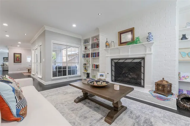 a living room with furniture a fireplace and a table