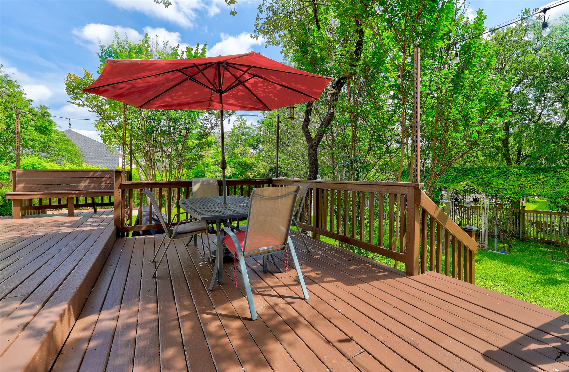 110 South Ridge Circle Georgetown, TX 78628 - Photo 32 of 37 Spacious wood deck featuring a built-in bench, wood railings, and ample space for outdoor seating