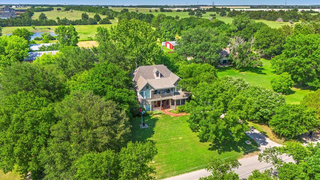 an aerial view of a house with a yard basket ball court and outdoor seating
