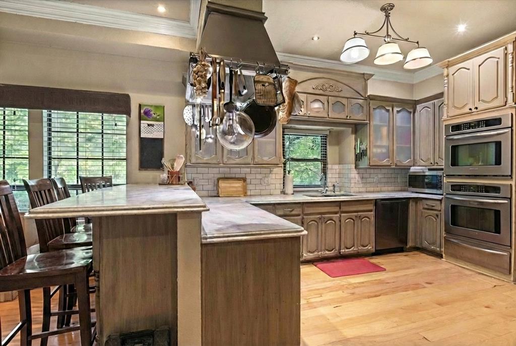1578 Stainback Road Red Oak, TX 75154 - Photo 14 of 37 a kitchen with stainless steel appliances granite countertop a sink stove and refrigerator