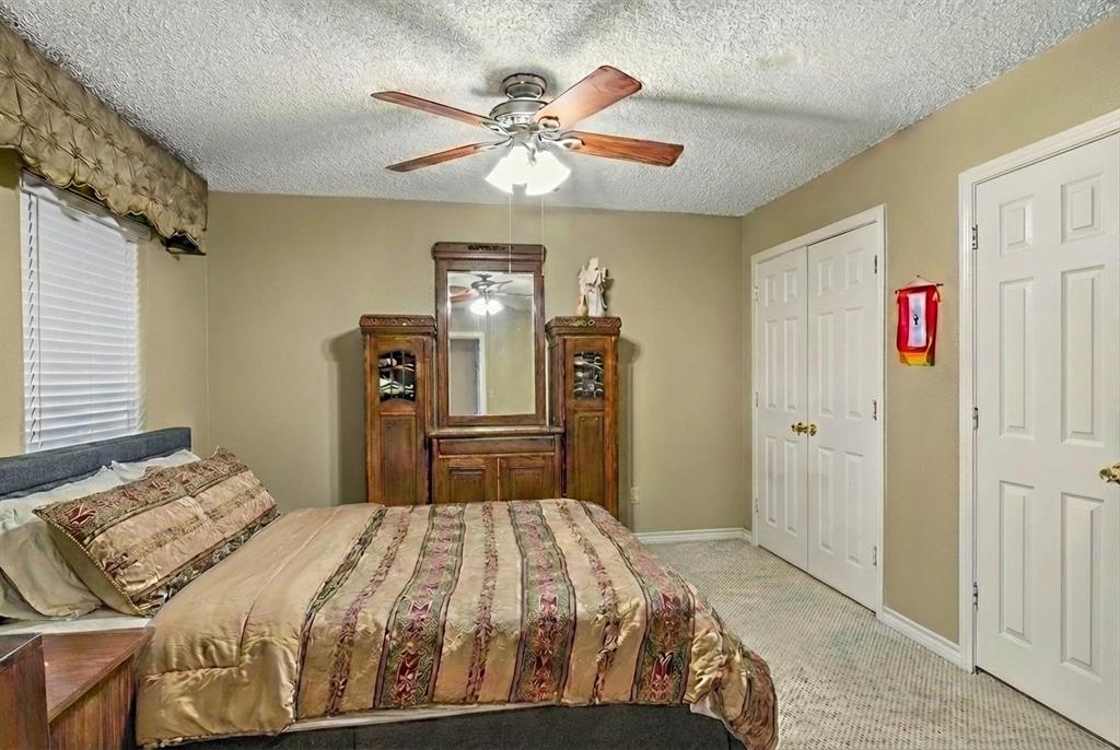 1578 Stainback Road Red Oak, TX 75154 - Photo 20 of 37 a bedroom with a bed and a chandelier