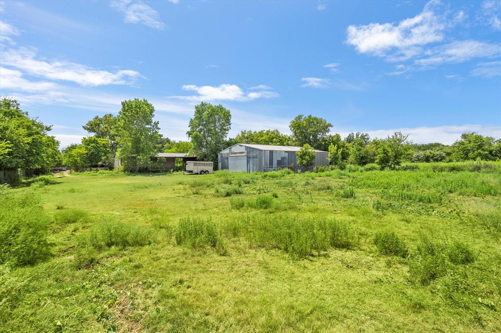 1578 Stainback Road Red Oak, TX 75154 - Photo 28 of 37 a view of a garden with a building in the background