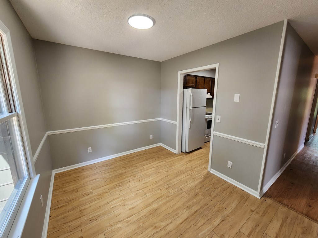 3658 Maryland Circle, Unit C Columbus, GA 31907 - Photo 5 of 8 an empty room with wooden floor and entrance