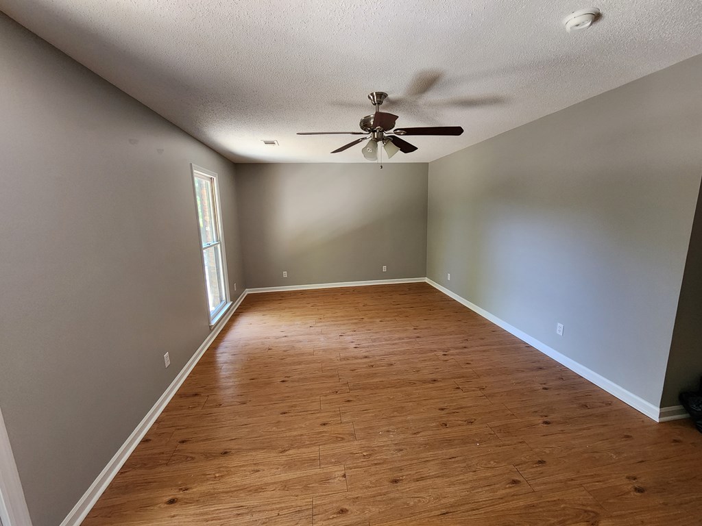 3658 Maryland Circle, Unit C Columbus, GA 31907 - Photo 8 of 8 wooden floor in an empty room with a window