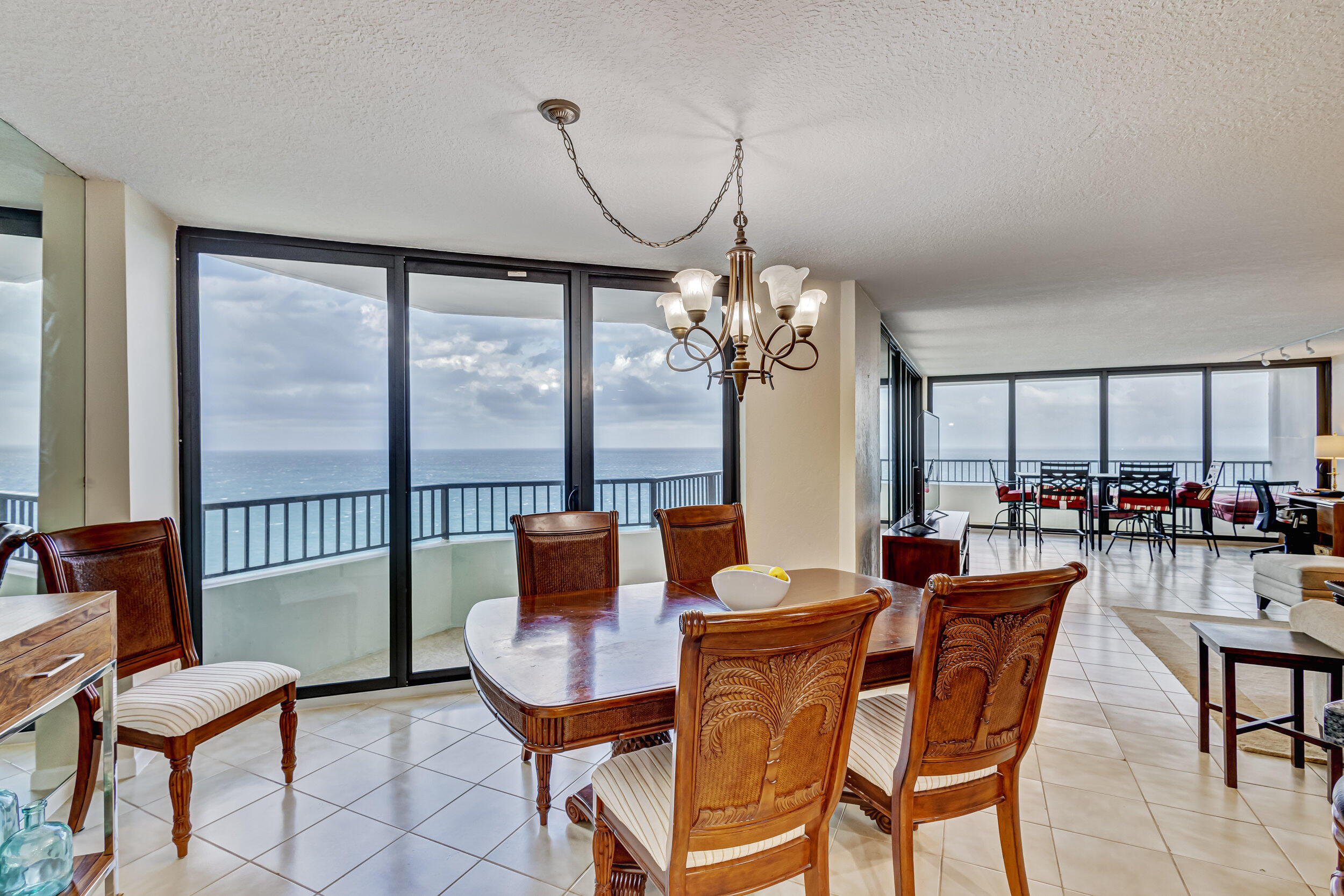 600 Ocean Drive, Unit 11A Juno Beach, FL 33408 - Photo 12 of 51 a dining room with furniture a chandelier and a rug
