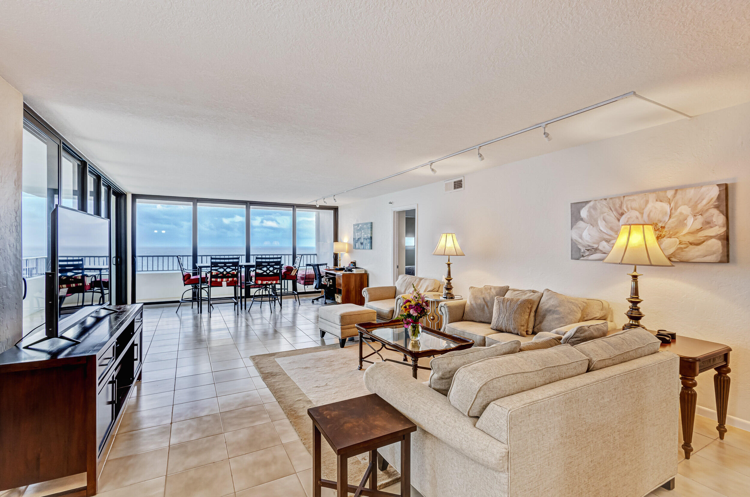 600 Ocean Drive, Unit 11A Juno Beach, FL 33408 - Photo 23 of 51 a living room with furniture and a flat screen tv