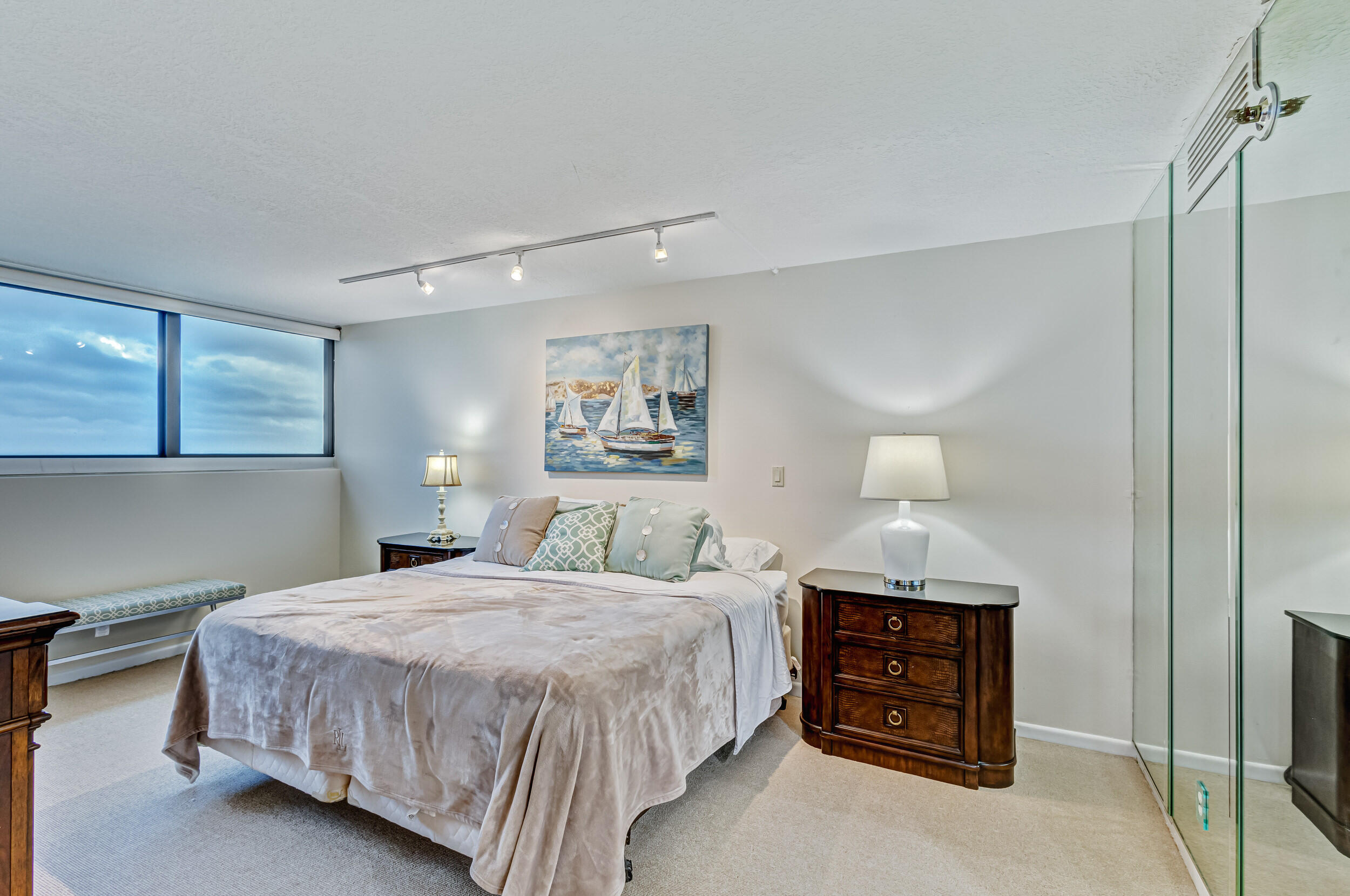 600 Ocean Drive, Unit 11A Juno Beach, FL 33408 - Photo 24 of 51 a bedroom with a bed and a night stand