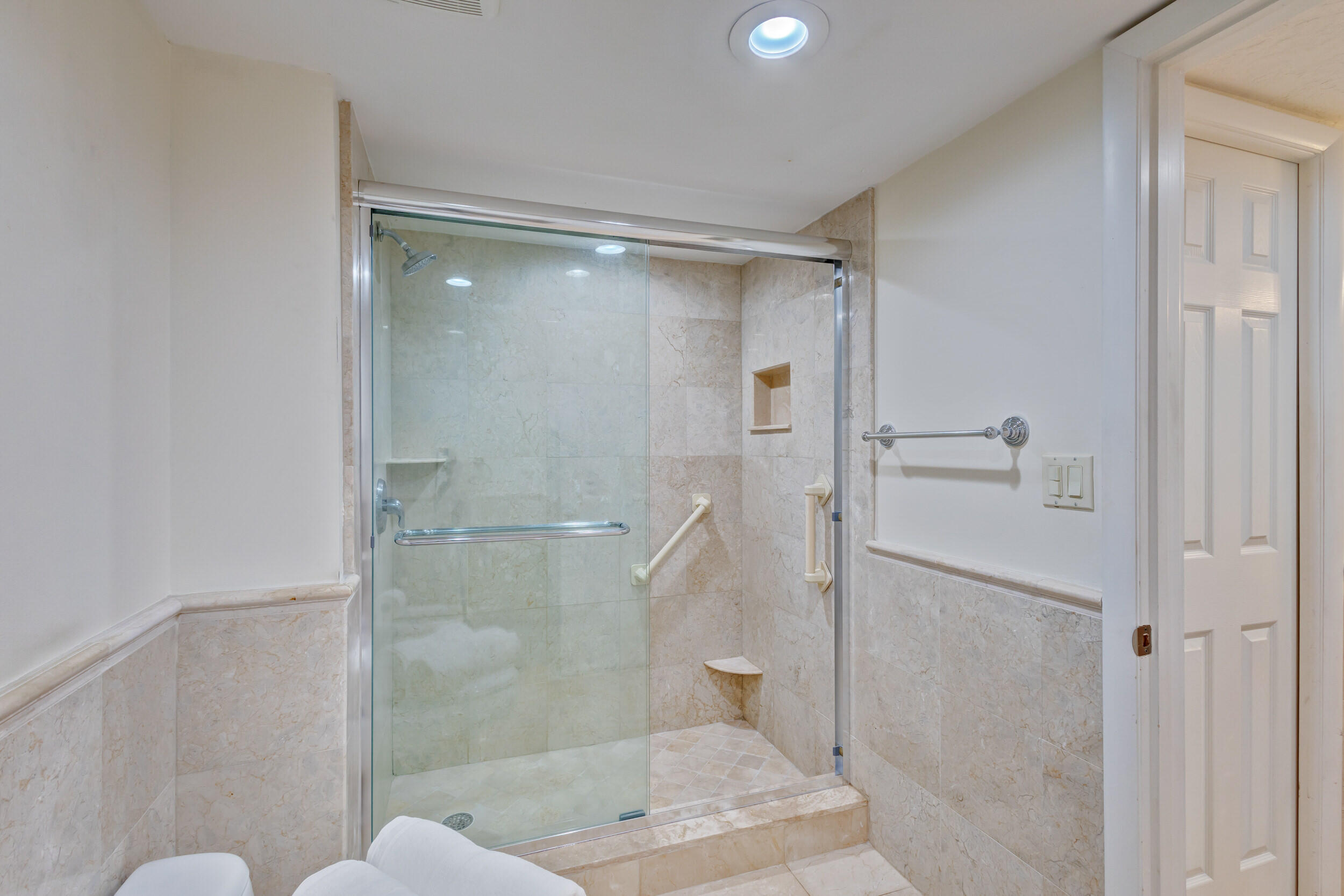 600 Ocean Drive, Unit 11A Juno Beach, FL 33408 - Photo 29 of 51 a bathroom with a glass shower door